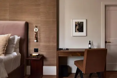 a bedroom with a desk with a bed and a chair at Stockton Inn in Stockton