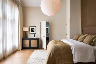 a bedroom with a bed and a large window at Stockton Inn in Stockton