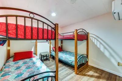a bedroom with two bunk beds and a bed at Home with Hot Tub and Arrowhead Lake Community Perks! in Pocono Lake