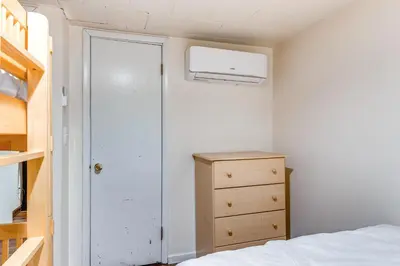 a bedroom with a bed and a closet and a dresser at Home with Hot Tub and Arrowhead Lake Community Perks! in Pocono Lake