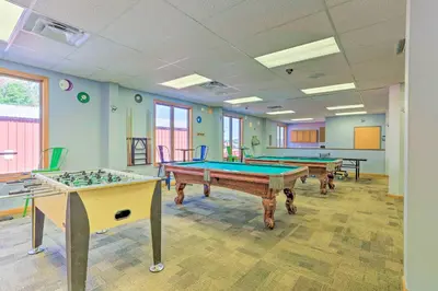 a room with three pool tables in it at Home with Hot Tub and Arrowhead Lake Community Perks! in Pocono Lake