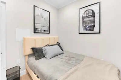 a bedroom with a bed with two pictures on the wall at Modern 3Bd Rose Hills Manhattan Terrace Space in New York