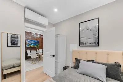 a bedroom with a bed and a dining room at Modern 3Bd Rose Hills Manhattan Terrace Space in New York
