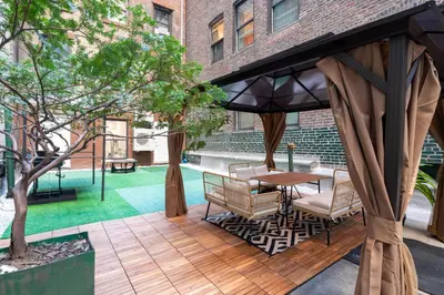 a gazebo with a table and chairs on a patio at Modern 3Bd Rose Hills Manhattan Terrace Space in New York