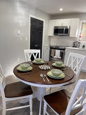 a kitchen with a wooden table with plates and silverware at Cabin near kalahari,camelback Ski in Long Pond