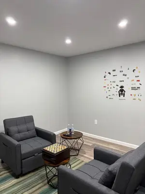 a living room with two couches and a white wall at Cabin near kalahari,camelback Ski in Long Pond