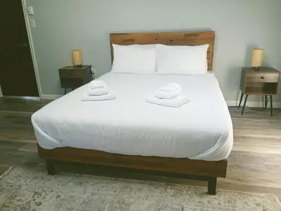 a bedroom with a large bed with two towels on it at Cabin near kalahari,camelback Ski in Long Pond
