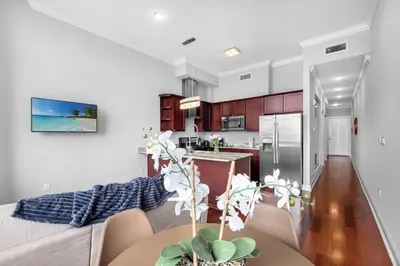 a kitchen and living room with a couch and a table at Stylish 1BR - Rooftop Pool in Philadelphia