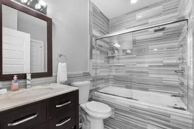 a bathroom with a tub and a toilet and a sink at Stylish 1BR - Rooftop Pool in Philadelphia