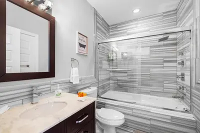 a bathroom with a tub and a toilet and a sink at Stylish 1BR - Rooftop Pool in Philadelphia