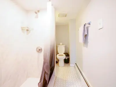 a bathroom with a shower and a toilet at Bright and Airy Studio Apt Minutes to NYC in Jersey City