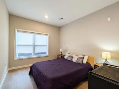 a bedroom with a bed and a window at 313 brand new 3 bedroom 2 bath in Dunellen