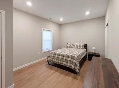 a bedroom with a bed and a window at 313 brand new 3 bedroom 2 bath in Dunellen