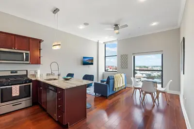 a kitchen and living room with a table and chairs at Lavish 1BR with Pool & Gym Access in Philadelphia