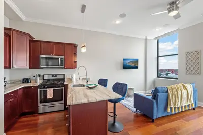 a kitchen with a counter and a table in a room at Lavish 1BR with Pool & Gym Access in Philadelphia