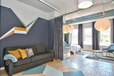 a living room with a couch and a bedroom at Wonder Honesdale -Loft A2 in Honesdale