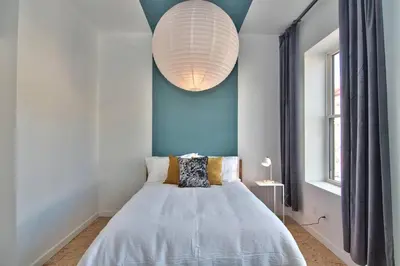 a bedroom with a bed and a large light fixture at Wonder Honesdale -Loft A2 in Honesdale