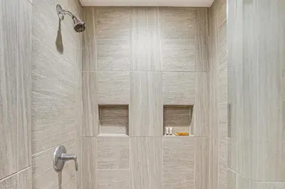 a bathroom with a shower with a glass door at The Grotto - Unique Interactive Cave Experience in Spring City