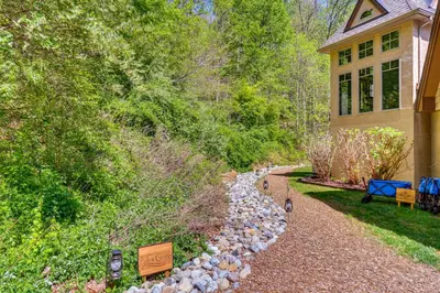a home with a gravel path next to a house at The Grotto - Unique Interactive Cave Experience in Spring City