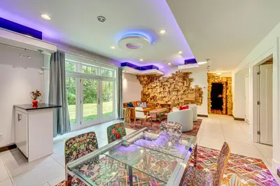 a living room with a glass table and chairs at The Grotto - Unique Interactive Cave Experience in Spring City