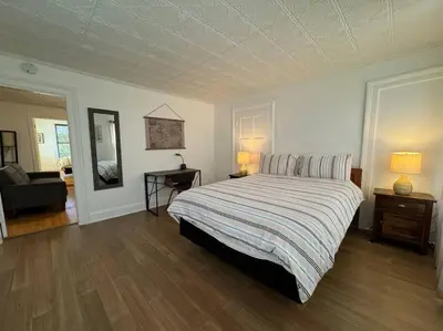 a bedroom with a large bed with a striped blanket at Private Apartment with NYC VIEWS right outside NYC in Jersey City