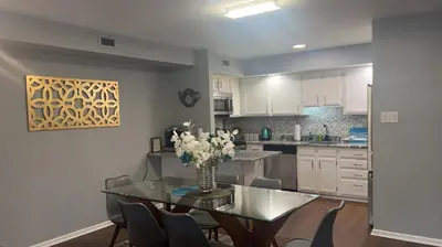 a kitchen with a glass table with a vase of flowers on it at Turquoise Gem in Philadelphia