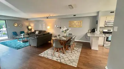 a living room with a couch and a table with chairs at Turquoise Gem in Philadelphia