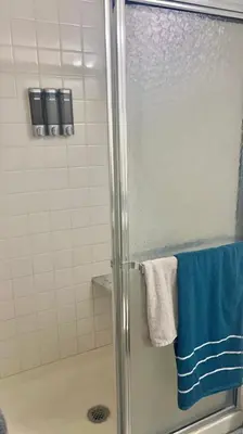 a bathroom with a shower with blue and white towels at Turquoise Gem in Philadelphia