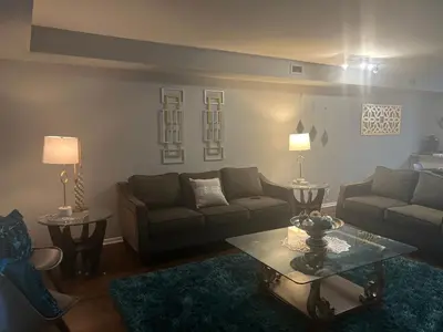 a living room with a couch and a table at Turquoise Gem in Philadelphia