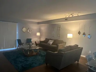 a living room with a couch and a table at Turquoise Gem in Philadelphia