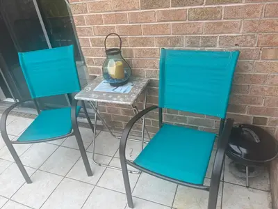 two blue chairs and a table with a vase at Turquoise Gem in Philadelphia