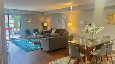 a living room with a couch and a table at Turquoise Gem in Philadelphia