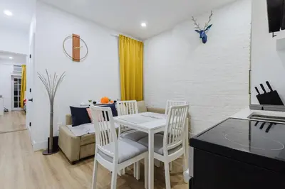 a kitchen and dining room with a table and chairs at 2 Bedroom Modern Unit in Central Manhattan in New York