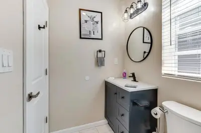 a bathroom with a sink and a mirror at Townhouse - Urban Living with Rooftop Deck! in Newark