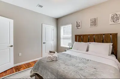 a bedroom with a large bed with two towels on it at Townhouse - Urban Living with Rooftop Deck! in Newark