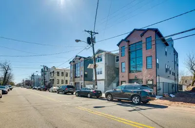 a street with cars parked on the side of the road at Townhouse - Urban Living with Rooftop Deck! in Newark