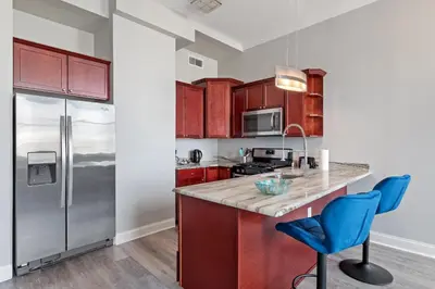a kitchen with a counter and a refrigerator at Magnificent 1BR with Pool & Gym in Philadelphia