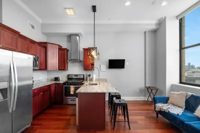 a kitchen with a refrigerator and a counter top at Chic NoLibs 1BR - Pool & Gym in Philadelphia