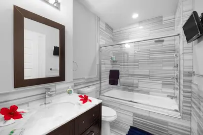 a bathroom with a tub and a sink and a toilet at Chic NoLibs 1BR - Pool & Gym in Philadelphia