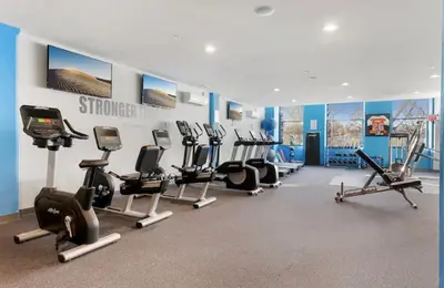 a gym with several treadmills and cardio machines at Chic NoLibs 1BR - Pool & Gym in Philadelphia