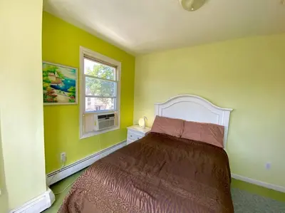 a bedroom with a bed and a window at 3-bedrooms Journal Square near NYC in Jersey City