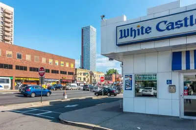 a white castle store on a city street with cars at 3-bedrooms Journal Square near NYC in Jersey City