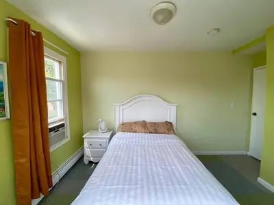 a bedroom with a bed and a window at 3-bedrooms Journal Square near NYC in Jersey City