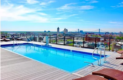 a swimming pool on the roof of a building at Modern NoLibs 1BR - Pool & Gym in Philadelphia