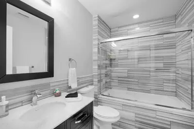 a bathroom with a tub and a toilet and a sink at Modern NoLibs 1BR - Pool & Gym in Philadelphia