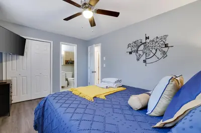 a bedroom with a blue bed with a ceiling fan at Lakeview! - Close to Skiing - Includes Firepit & Game Room! in Arrowhead Lake
