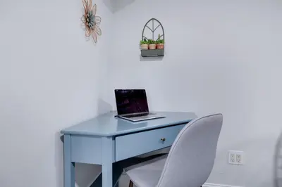 a blue desk with a laptop and a chair at Lakeview! - Close to Skiing - Includes Firepit & Game Room! in Arrowhead Lake