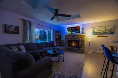 a living room with a couch and a fireplace at Lakeview! - Close to Skiing - Includes Firepit & Game Room! in Arrowhead Lake