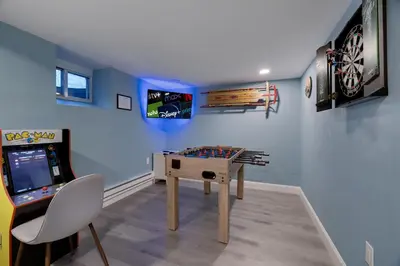 a room with a table and a video game at Lakeview! - Close to Skiing - Includes Firepit & Game Room! in Arrowhead Lake