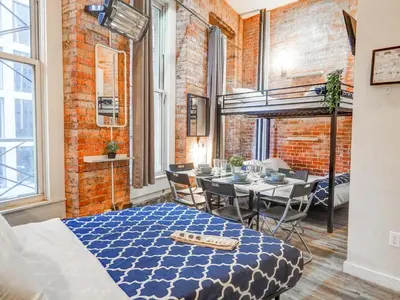 a dining room with a bed and a dining table at Metropolitan Studio Apartments Manhattan in New York